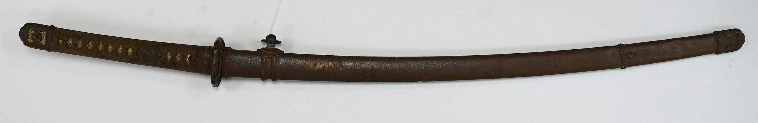 A Japanese WWII army officer’s sword Katana, blade 65cm, signed tang, retaining good polish, in shin gunto mounts. Condition - good